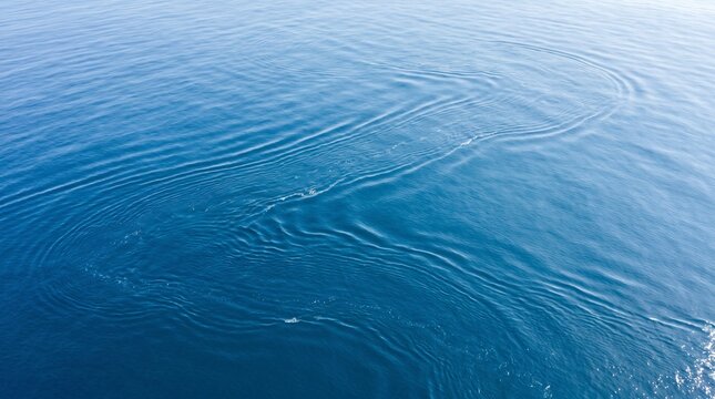 Aerial view of calm deep blue ocean.
