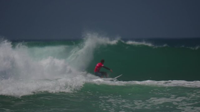 Surfers ripping across the waves in huntington beach