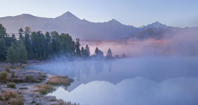 Mountain lake on an foggy morning, autumn landscape, forest