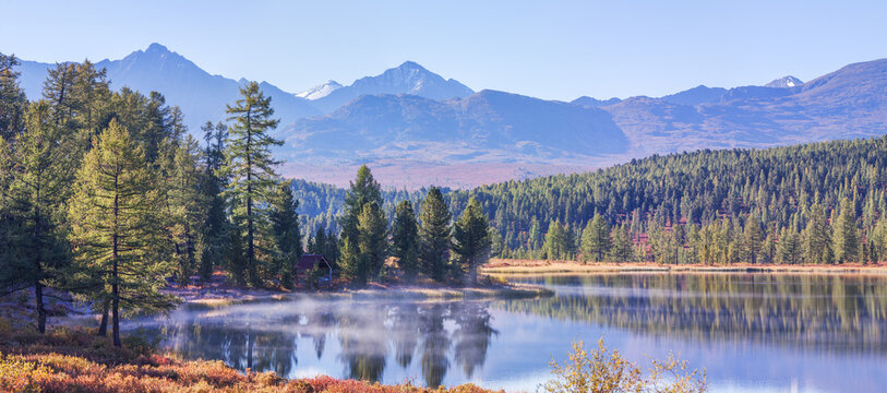 Mountain lake on an autumn morning, forest shores, panoramic view