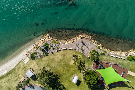 Aerial view of Foreshore Park at Settlement Point in Port Macquarie, featuring the waterfront reserve, surrounding greenery and scenic waters of the Hastings River on the Mid North Coast 