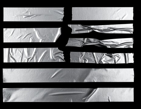 realistic torn masking tape strips with wrinkled silver plastic textures and adhesive edge isolated on black background