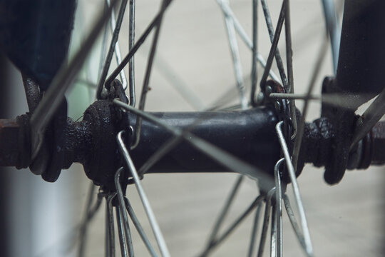 Close up of vintage bicycle wheel hub with metal spokes and axle.A high-quality close-up macro shot focusing on the central hub assembly of a classic bicycle wheel. 