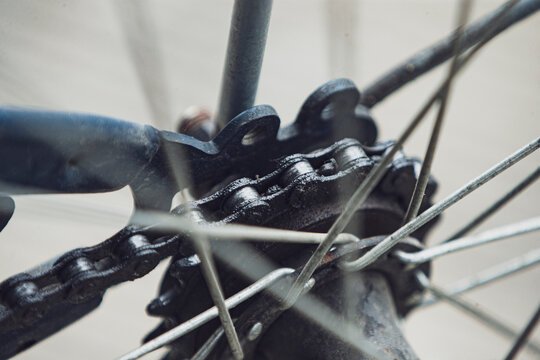 Close up of greasy bicycle chain on rear wheel cassette sprocket.A detailed macro shot focusing on a greasy and well-lubricated bicycle chain wrapped around the rear wheel cassette sprocket gear. 