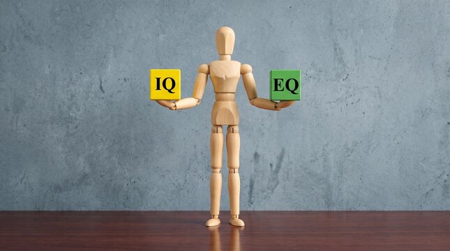 Wooden mannequin balancing IQ and EQ cubes representing intelligence and emotional quotient