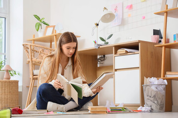 Education and learning at home, young woman studying with books on the floor in a bright student...