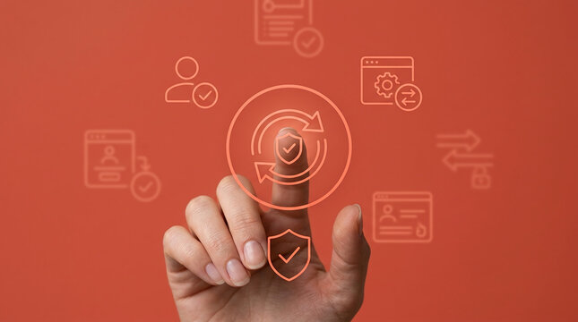 Hand touching digital security shield icon for cybersecurity protection, data privacy management, and software updates on a solid orange background