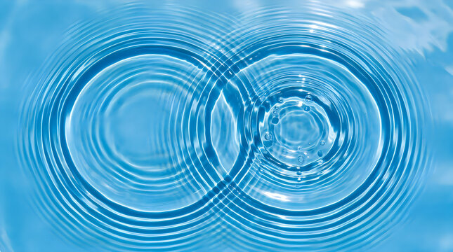 Two overlapping water splash rings on blue background
