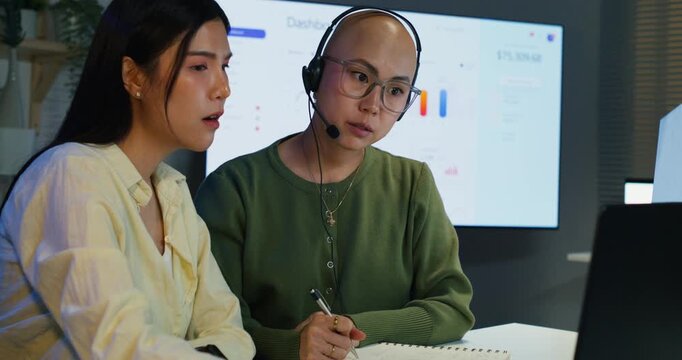 Business team analyzing telecom technology together, working late to develop digital solutions and enhance customer communication strategies in a modern workplace.