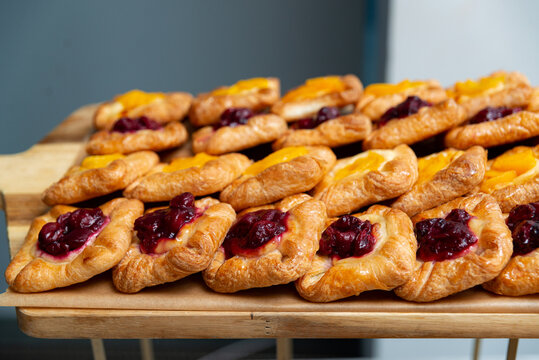 Assorted fruit danishes with berry and peach filling on tray