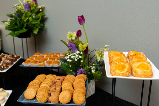 Freshly baked pastries with colorful floral arrangements.