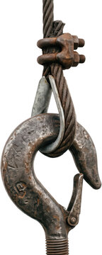 Close up of a heavy duty rusted steel crane hook connected to a thick wire rope sling secured with a metal cable clamp showing weathered industrial texture and mechanical strength