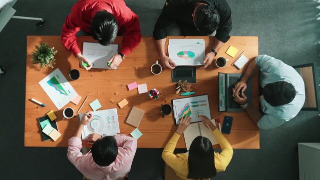 Top view of businesswoman hold tablet display financial graph and place on meeting table with sticky notes. Project manager looking at stock market statistic and analyzing data analysis. Convocation.