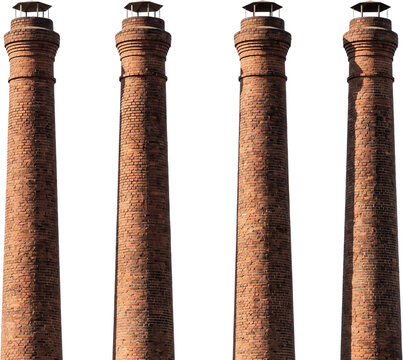Four tall vintage industrial chimneys made of red bricks standing vertically in a row under bright daylight showing detailed masonry work metallic caps and structural architecture