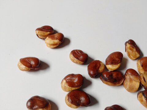 close up of cashews, Roasted cashews scattered on White Background