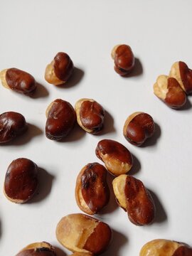 close up of cashews, Roasted cashews scattered on White Background