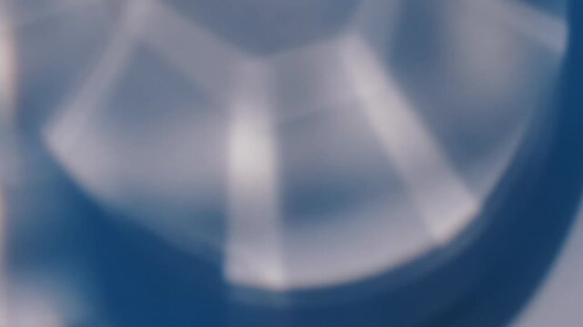 Defocused fractal reflection. Glow light. Blur blue white color lens kaleidoscope illuminated flicker leaking on abstract creative optical background.