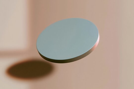 Blank round cardboard coaster with a soft blue hue and fine paper texture, floating against a warm amber background for product mockup and design template
