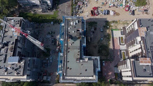 Tower Crane Over New Apartment Buildings Under Construction Aerial View. San Donato Milanese, Milan, Italy