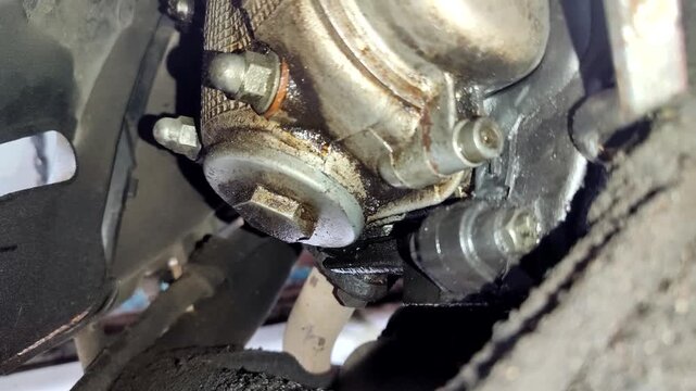 Leaking motorbike oil seeps into the bottom of the motorbike