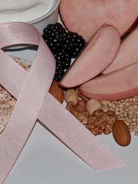 Pink awareness ribbon with healthy food and fresh fruit