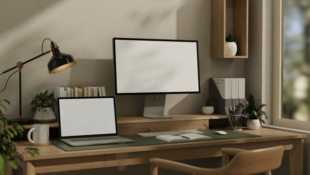 Computer monitor and laptop mockup with blank screens on wooden desk workspace 3D render