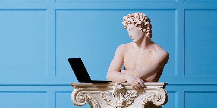 White marble statue of a man leaning over an ornate console with a black laptop, featuring a smooth chiseled texture for creative agency mockup and copy space