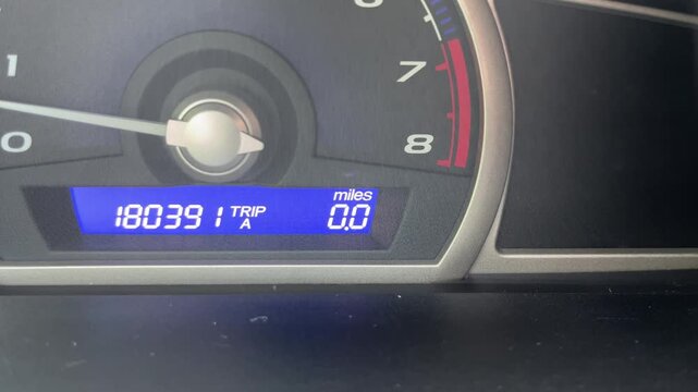 Car digital dashboard display unit switching from kilometers to miles
