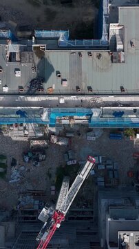 Tower Crane Over New Apartment Buildings Under Construction Aerial View. San Donato Milanese, Milan, Italy