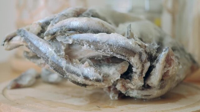 Frozen fish being prepared in a kitchen setting