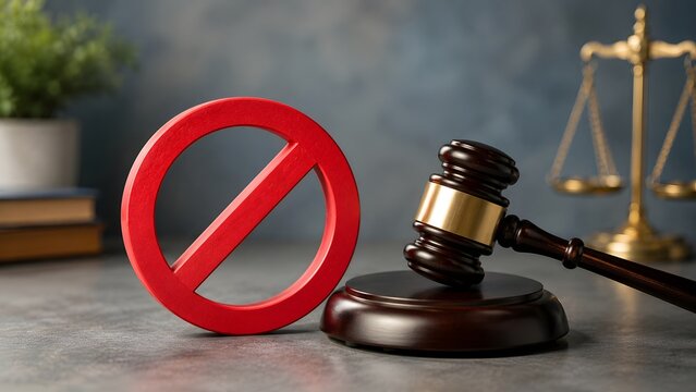 Red prohibited sign beside wooden judge gavel and brass scales. Concept of legal restriction enforcement, judicial court injunction, and penalty.