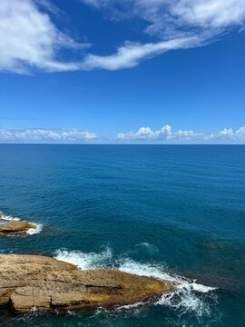 Coastal landscape with rocky cliffs and blue sea.