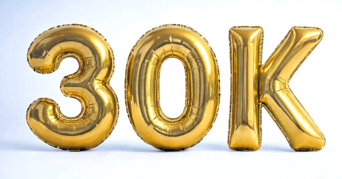 Golden shiny foil balloons with numbers and letter spelling thirty k celebration display isolated