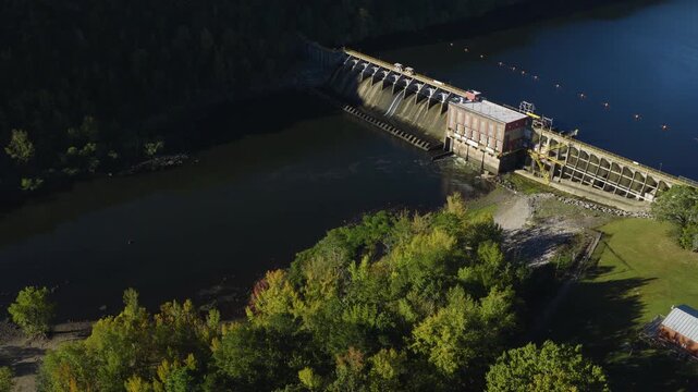 Drone angled pullback above treeline bordering Remmel Dam and hydroelectric facility, Ouachita River Jones Mill Arkansas USA