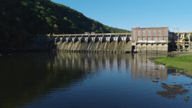 Low aerial upward angle of Remmel Dam reflected across still water, drone, Ouachita River Jones Mill Arkansas USA