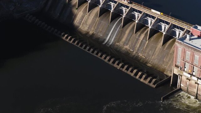 Detailed aerial of spillway gates at Remmel Dam, drone medium tracking right, Ouachita River Jones Mill Arkansas USA
