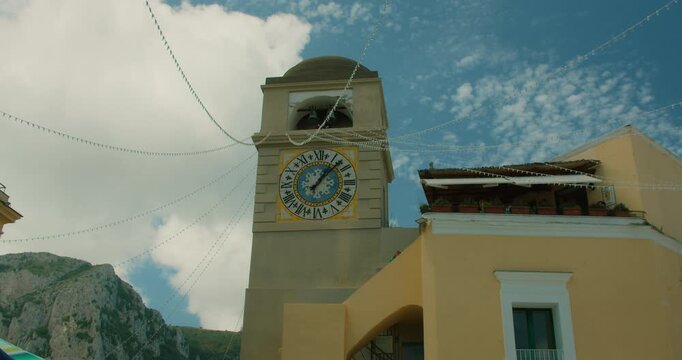 Charming old clock tower in Anacapri town in Capri Italy on a bright summer day