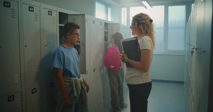 Enthusiastic Teacher Shares Good News with Teenage Student in School Changing Area, and Inspiring to Keep Striving Toward Future Goals. Mentorship, and Student Development in Everyday School Life.