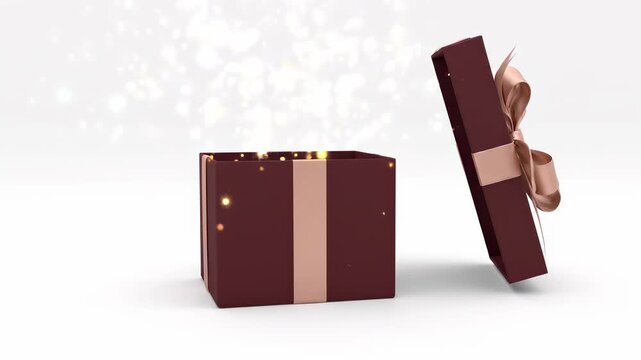 A beautifully wrapped gift box opens to reveal a dazzling burst of golden light and sparkling particles. Ideal for celebrations.