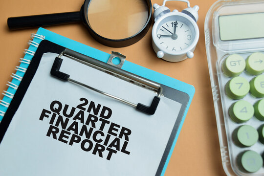 Concept of 2nd quarter financial report write on clipboard isolated on table.