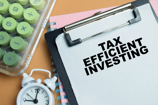 Concept of tax efficient investing write on clipboard isolated on table.