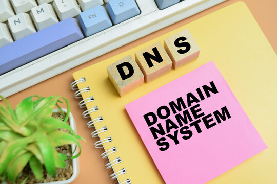 Concept of DNS - Domain Name System write on sticky notes isolated on table.