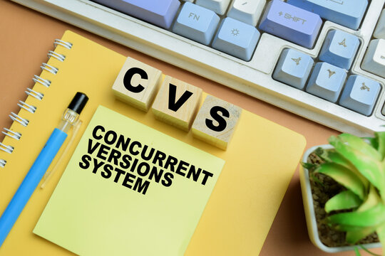 Concept of CVS - Concurrent Versions System write on sticky notes isolated on table.