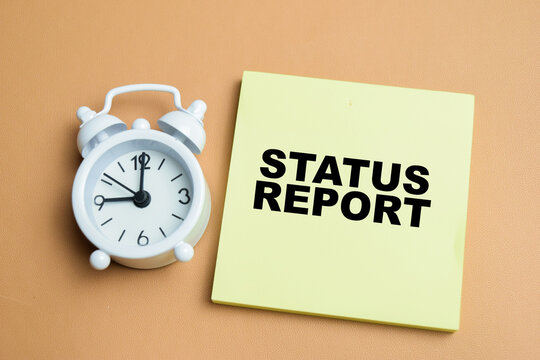 Concept of status report write on sticky notes isolated on table.