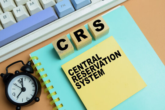 Concept of CRS - Central Reservation System write on sticky notes isolated on table.
