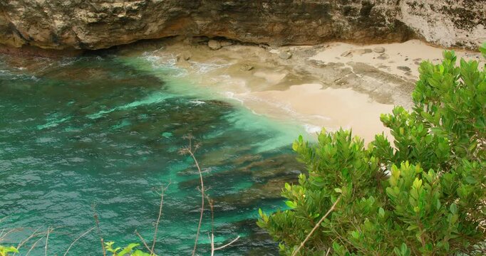 White sand beach and turquoise lagoon water framed by lush greenery Nusa Penida
