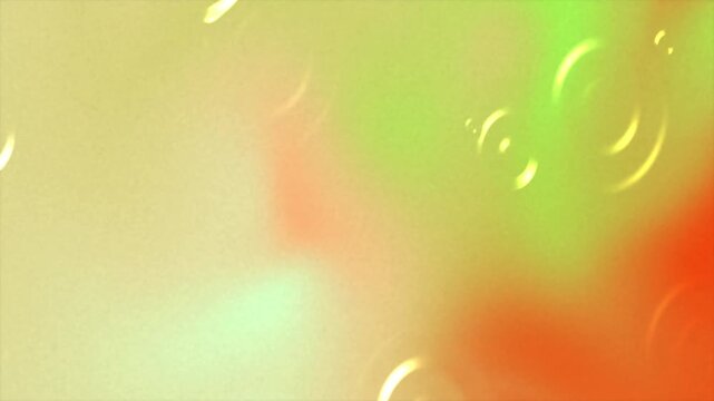 Abstract background with soft gradients of yellow green and orange colors and circular ripple patterns.