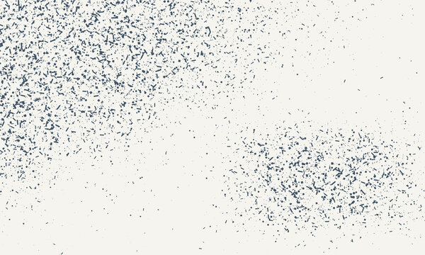 Abstract speckled texture in soft light with scattered dark particles on a pale background