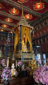 Golden Buddha statue enshrined inside the ordination hall of Buddhist temple in Bangkok, Thailand.