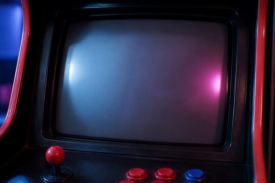 Retro arcade cabinet with joystick and buttons in neon light